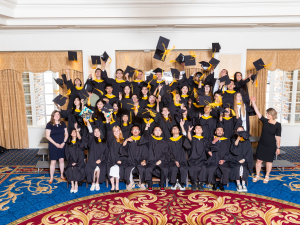 graduates toss their caps to celebrate 