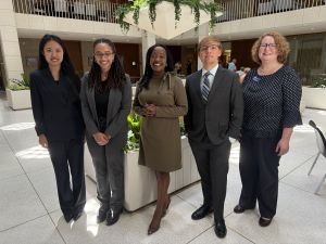 Catherine Wang stands next to two other Duke graduate students and two members of the NC Assembly
